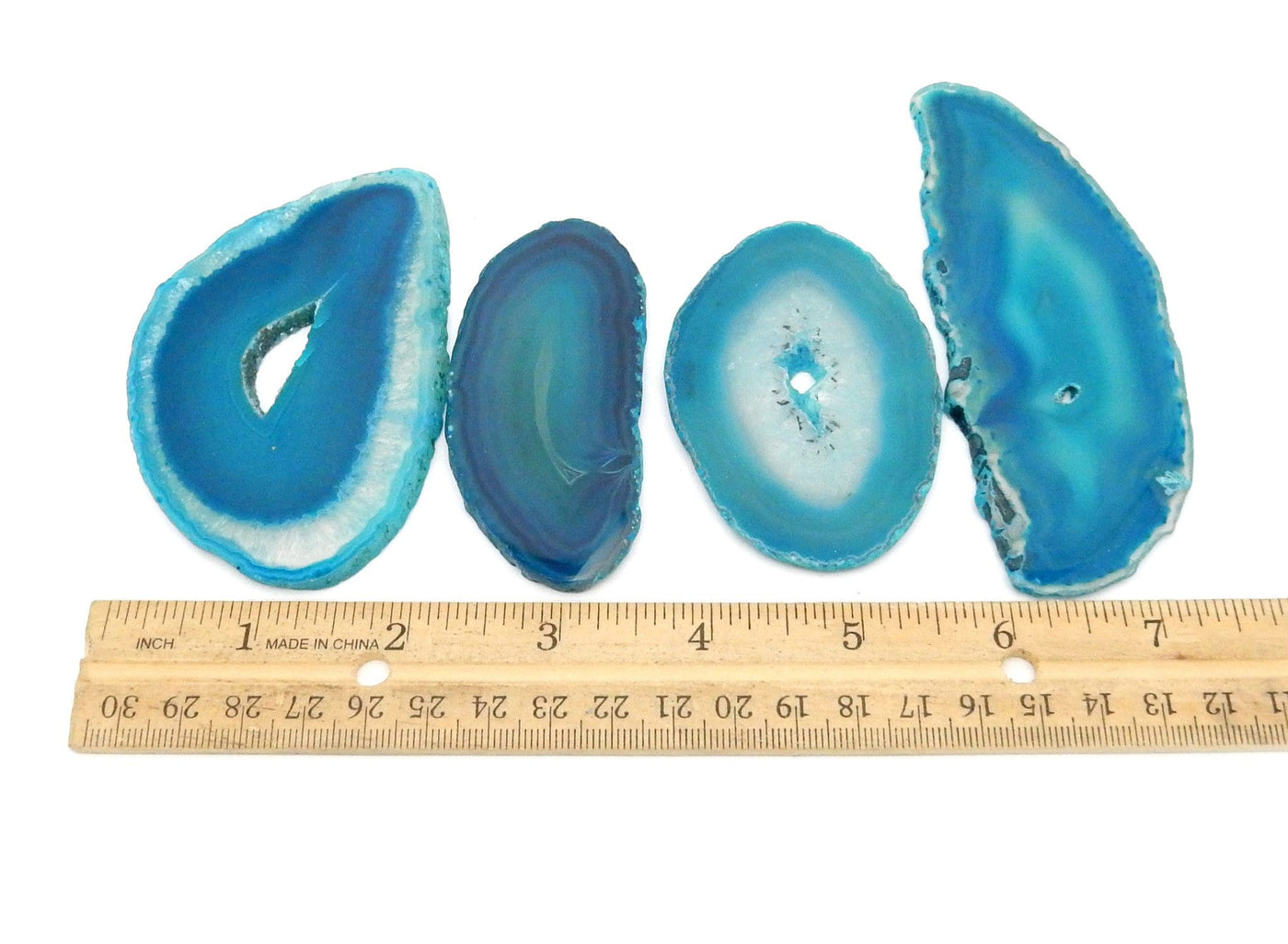 4 Teal Agate Slices in a Size number 1 next to a ruler for sizing