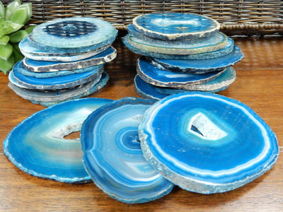 3 Teal Coaster with Open Druzy Center and 19 piece in the background stacked up on a table.