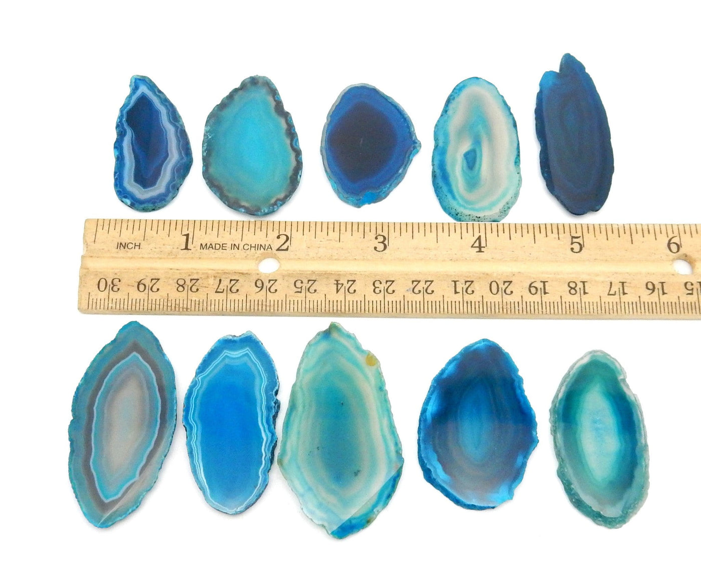 10 Teal Agate Slices Size 000 next to ruler for sizing 