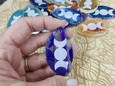 This picture is showing one of our purple agate slices being held for size reference.