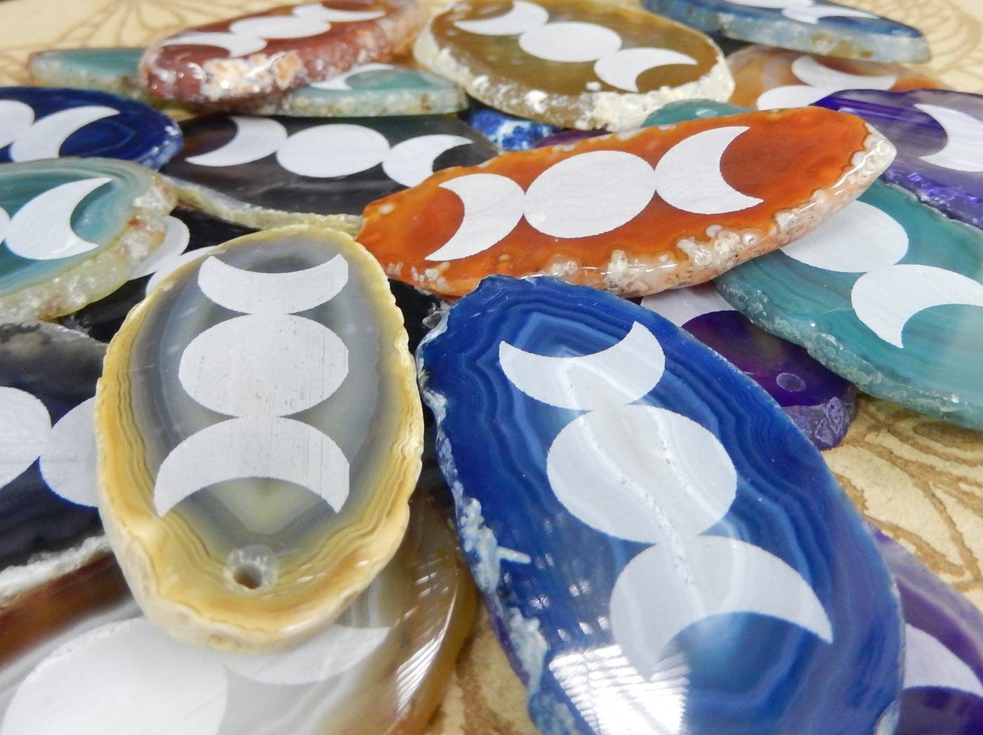 all of our agate slices are being displayed on a wooden surface.