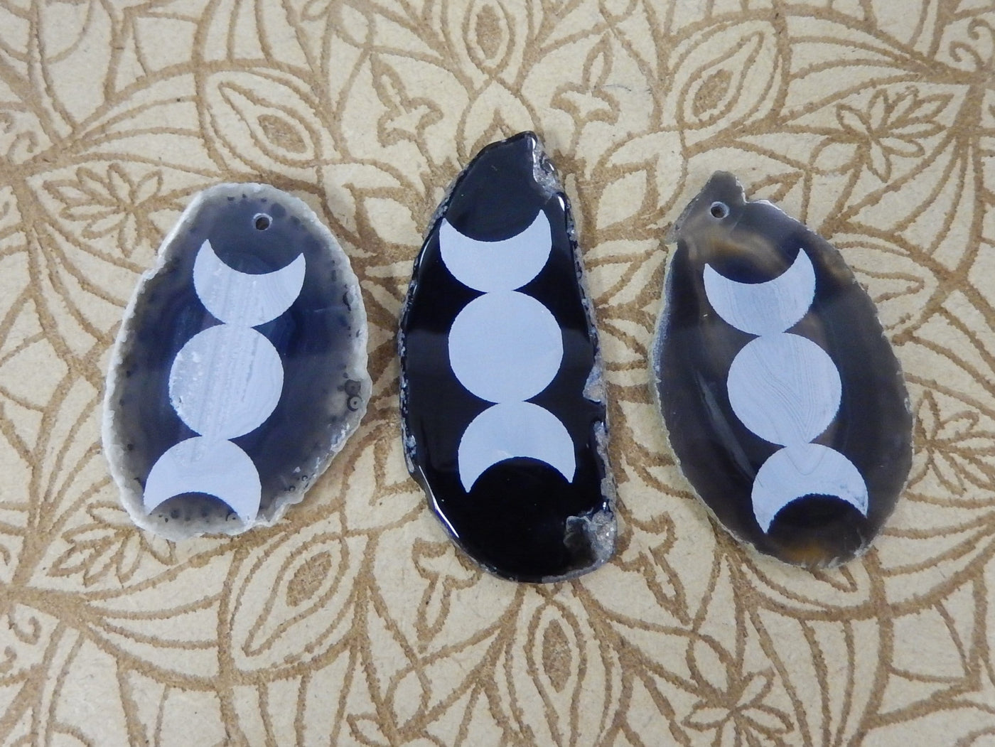 Picture of 3 of our black agate slice with large moon phase.