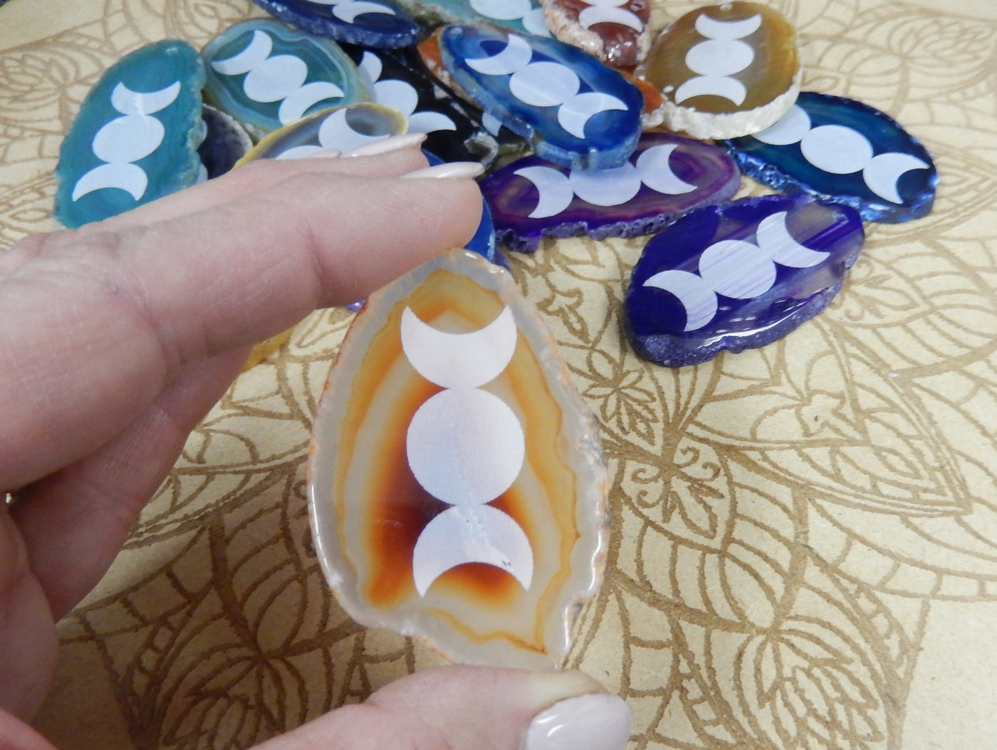 This picture is showing one of our natural agate slices being held for size reference.