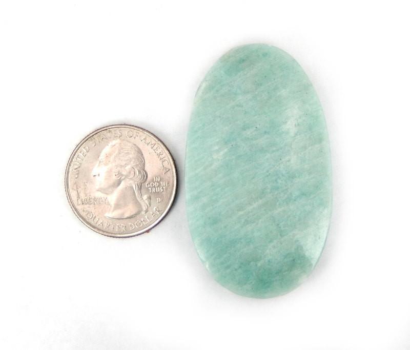 amazonite bead next to a quarter for size reference.