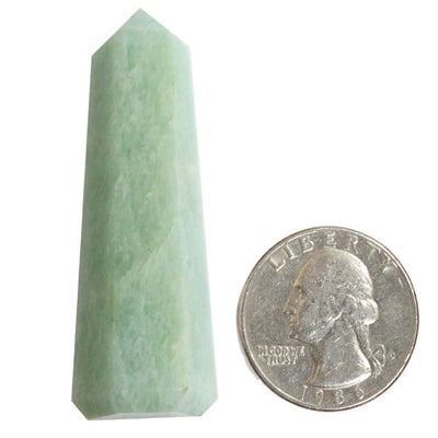 Picture of One amazonite crystal tower next to a quarter for size reference. 