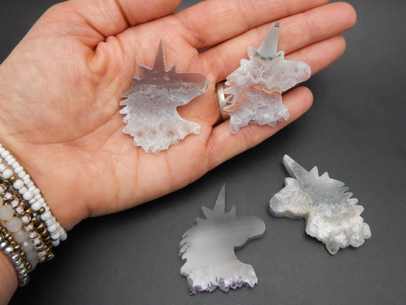 Amethyst Stalactite Unicorn Shaped Cabochons in hand for size reference