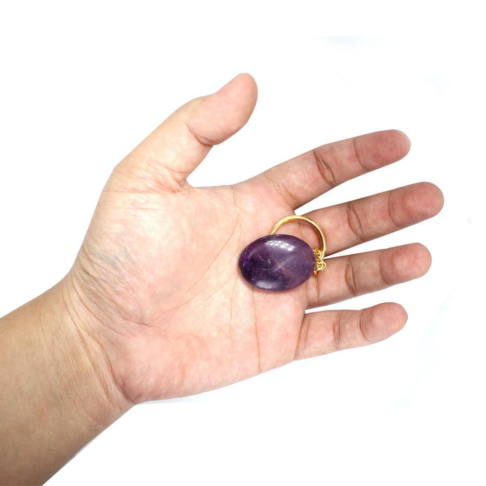 Amethyst Worry stone Keychain in a hand for size