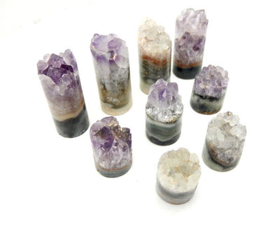 amethyst cylinders standing  up on a table