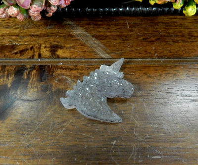 Natural Druzy Unicorn Shaped Cabochon Top Side Drilled Bead - one on a table