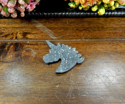 Natural Druzy Unicorn Shaped Cabochon  - one laying on a table