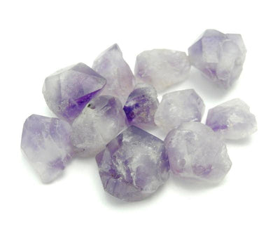 pile of Amethyst Point Top Side Drilled Beads on white background