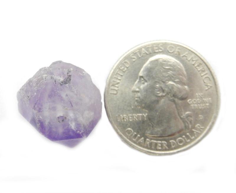 Amethyst Point Top Side Drilled Bead next to a quarter for size reference