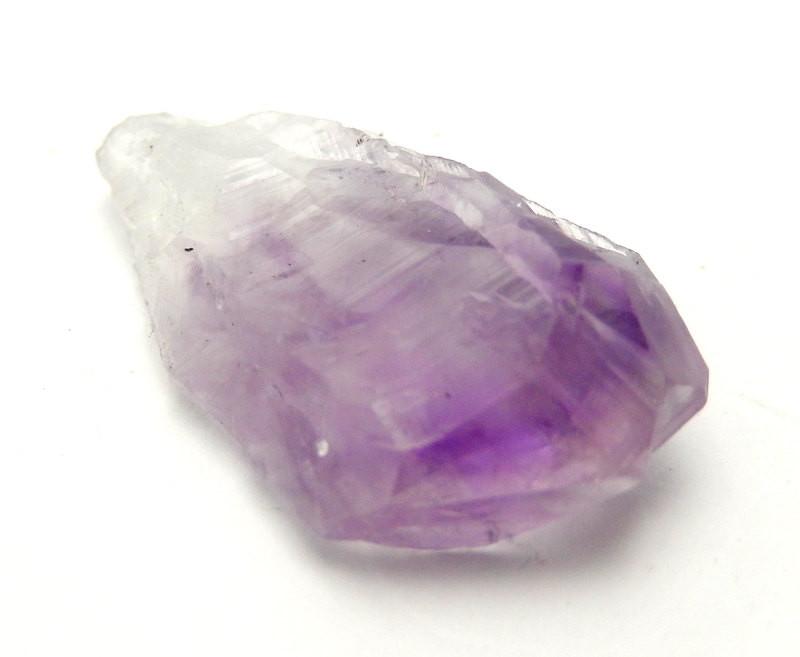 Side view of Amethyst Point on white, flat surface