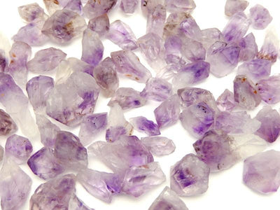 Various Amethyst Points laid out on a white surface