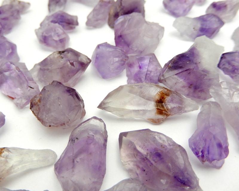 Up close view of various Amethyst Points on a white surface