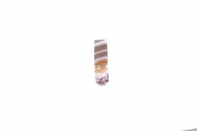 up close shot of amethyst slice on white background