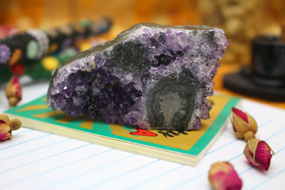 One Amethyst Stalactite On top of a Book. 
