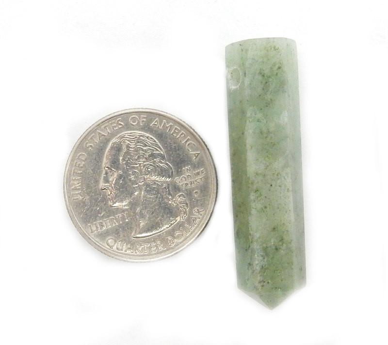 aquamarine drilled bead next to a quarter for size reference