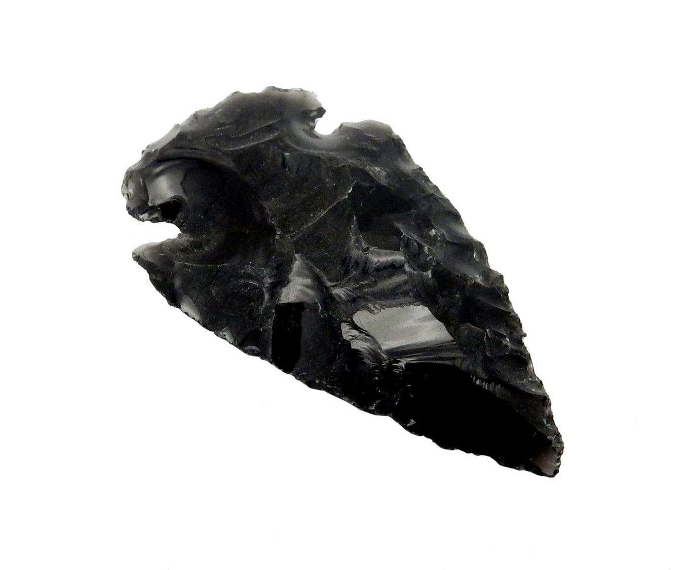 black obsidian arrowhead on a white arrowhead.