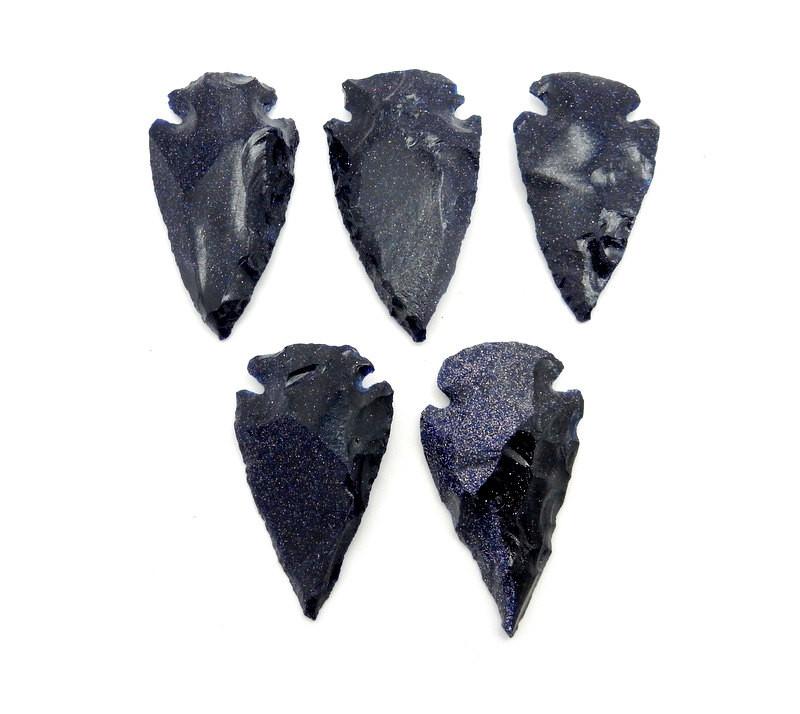 5 Blue Sunstone Arrowheads laid out on a white background to show various sheen color texture
