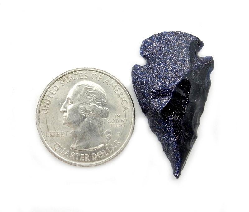 Blue Sunstone Arrowhead next to a quarter for size reference