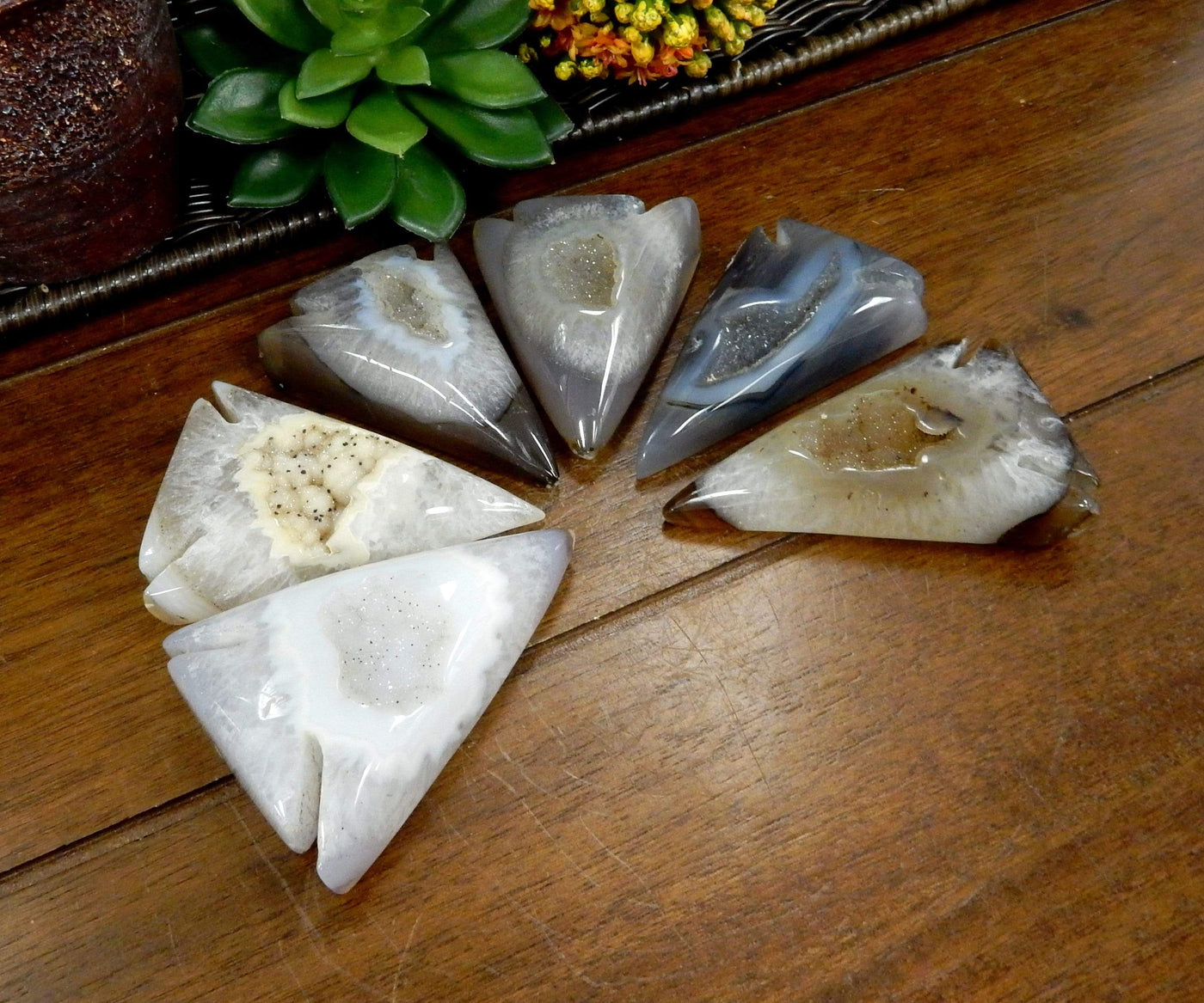An angled view of multiple agate druzy arrowhead shaped.