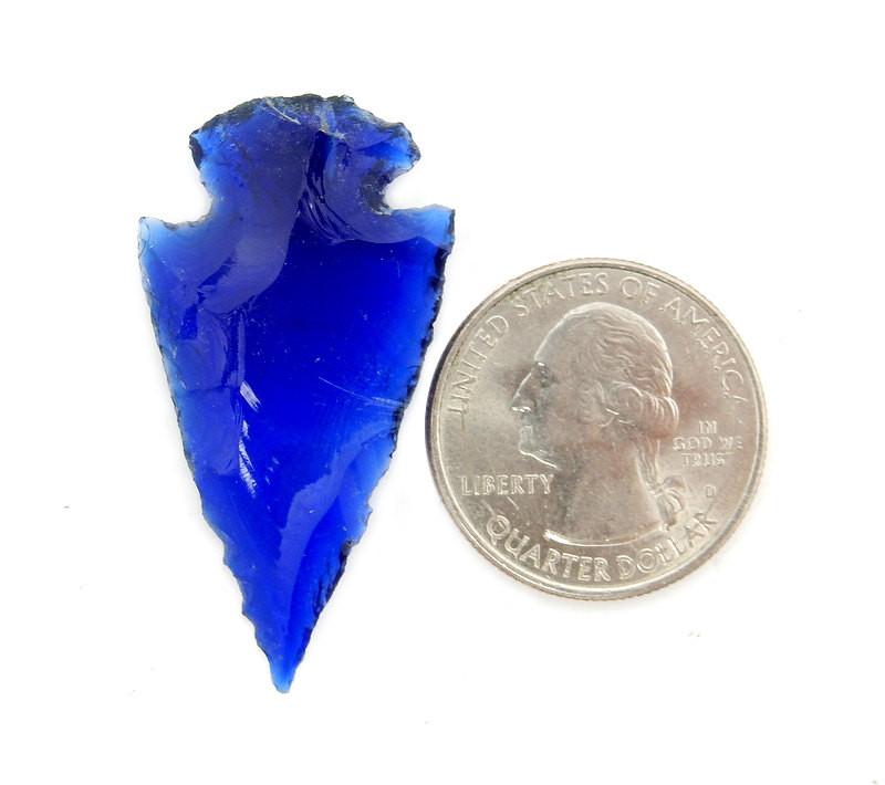 Cobalt blue arrowhead next to a quarter for size reference