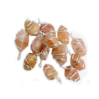 pile of Aventurine Silver Tone Spiral Tumbled Peach Aventurine Pendants on white background