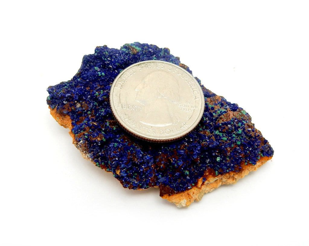 quarter on top of azurite stone for size reference on white background