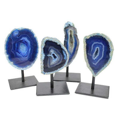 Four front facing agate geode on metal base showing color, pattern and shape variations. Displayed with a white background.