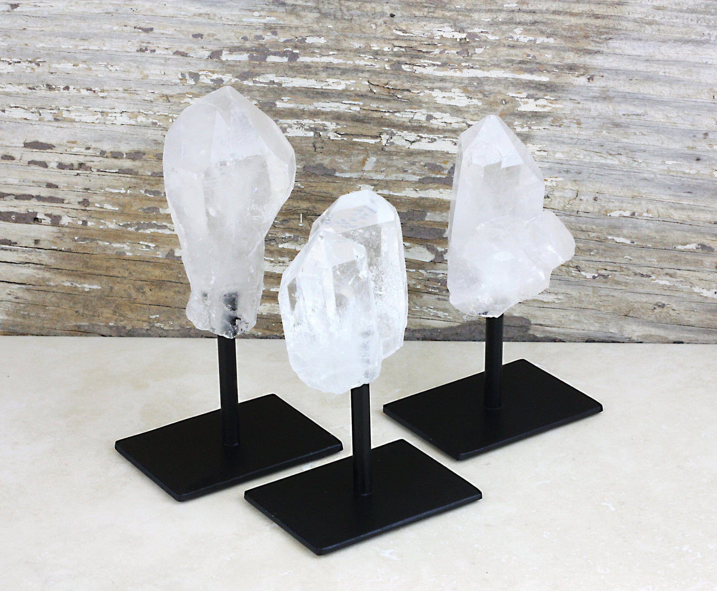 3 Crystal Quartz Point in Metal Bases on gray background