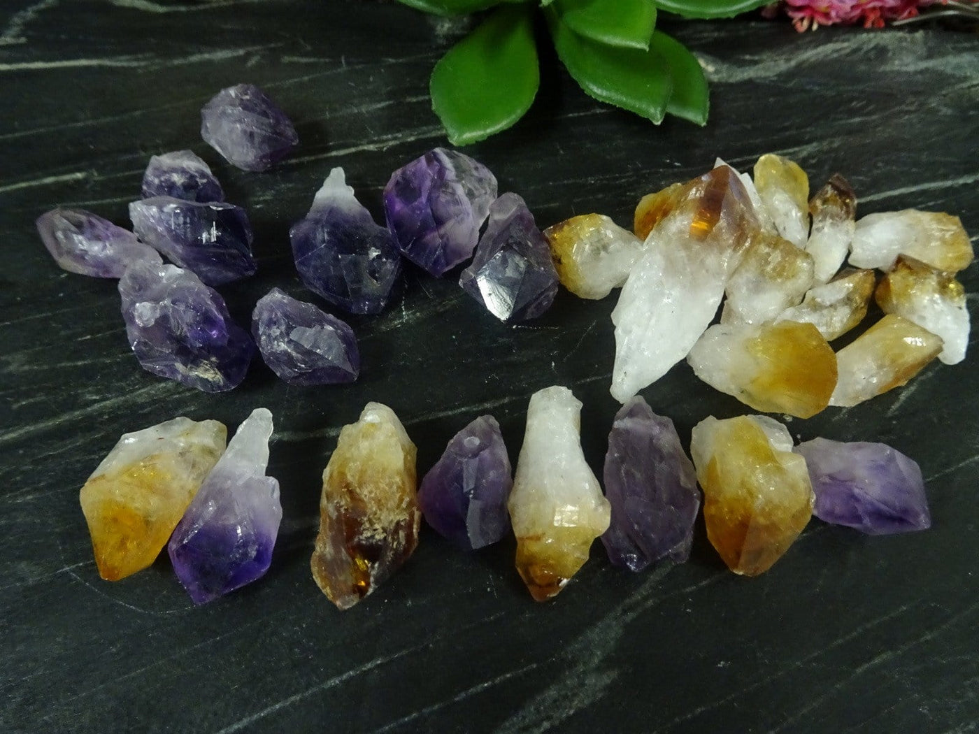 Amethyst and citrine assorted points on a dark background.
