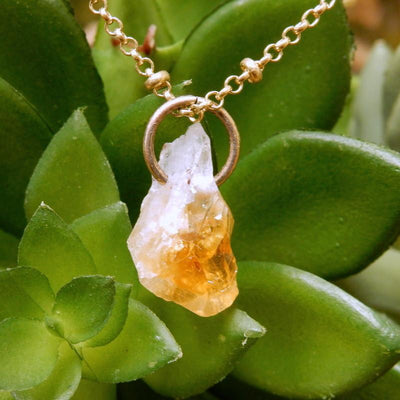 One citrine point on a chain with a jump ring through the hole.