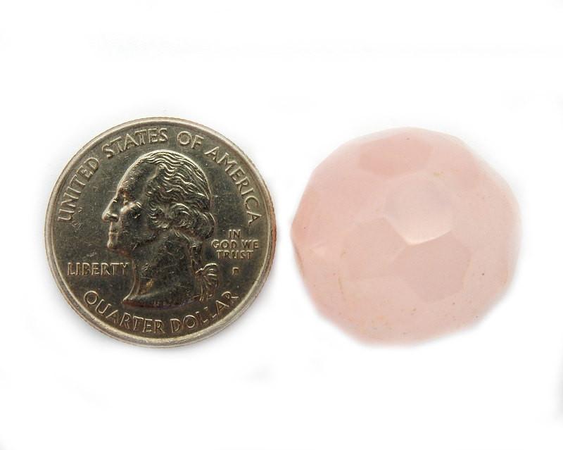 Rose Quartz Bead next to a quarter for size comparison on white background