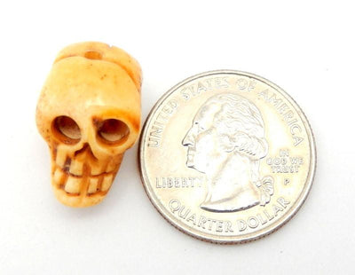skull bead next to quarter for size reference