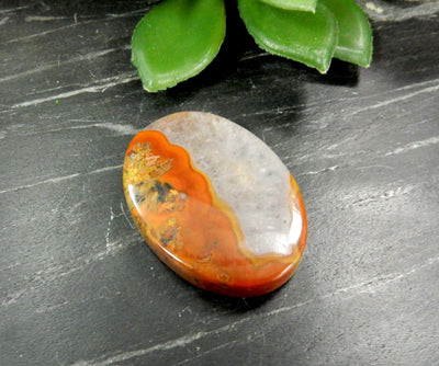 Up close shot of Red Chinese Agate Oval Shaped Bead on black background