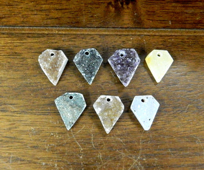 Druzy Diamond Drilled Cabochon, 7 laid on a table shown from top view for color/size reference