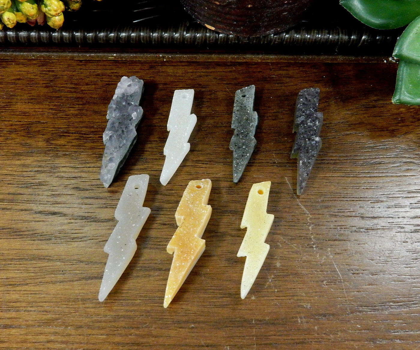Natural druzy lightning bolt beads displayed side view for thickness reference and texture differences