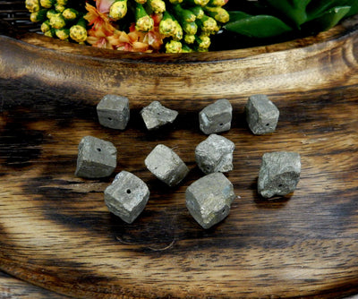 10 Pyrite Cube Side Drilled Beads on wooden background