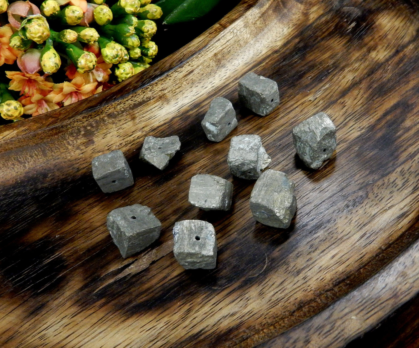 angled shot of 10 Pyrite Cube Side Drilled Beads on wooden background