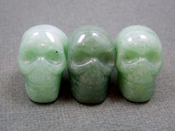 three aventurine skull beads in a row for possible variations
