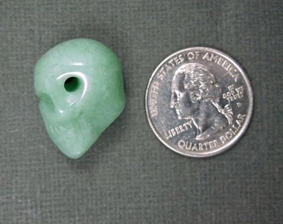 one aventurine skull bead with quarter for size reference