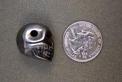 one grey hematite skull bead with quarter for size reference