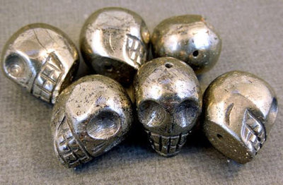 many hematite skull beads in a pile for possible variations