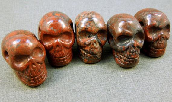many red brecciated jasper skull beads in a row for possible variations