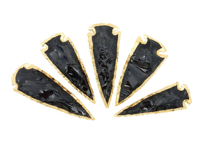 multiple Black Obsidian Arrowheads lined up to show various lengths and widths