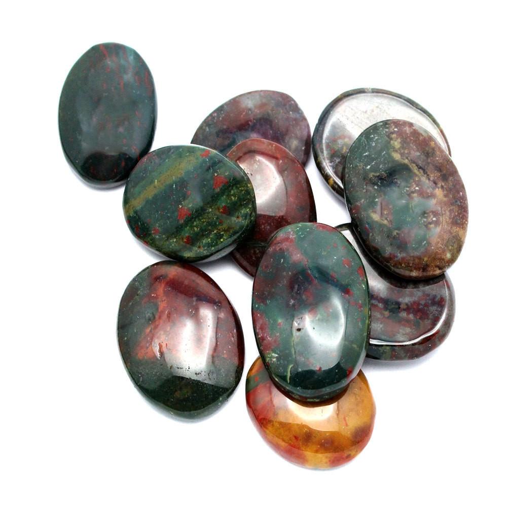 Blood Stone Worry Stone Slab  - a bunch on a table