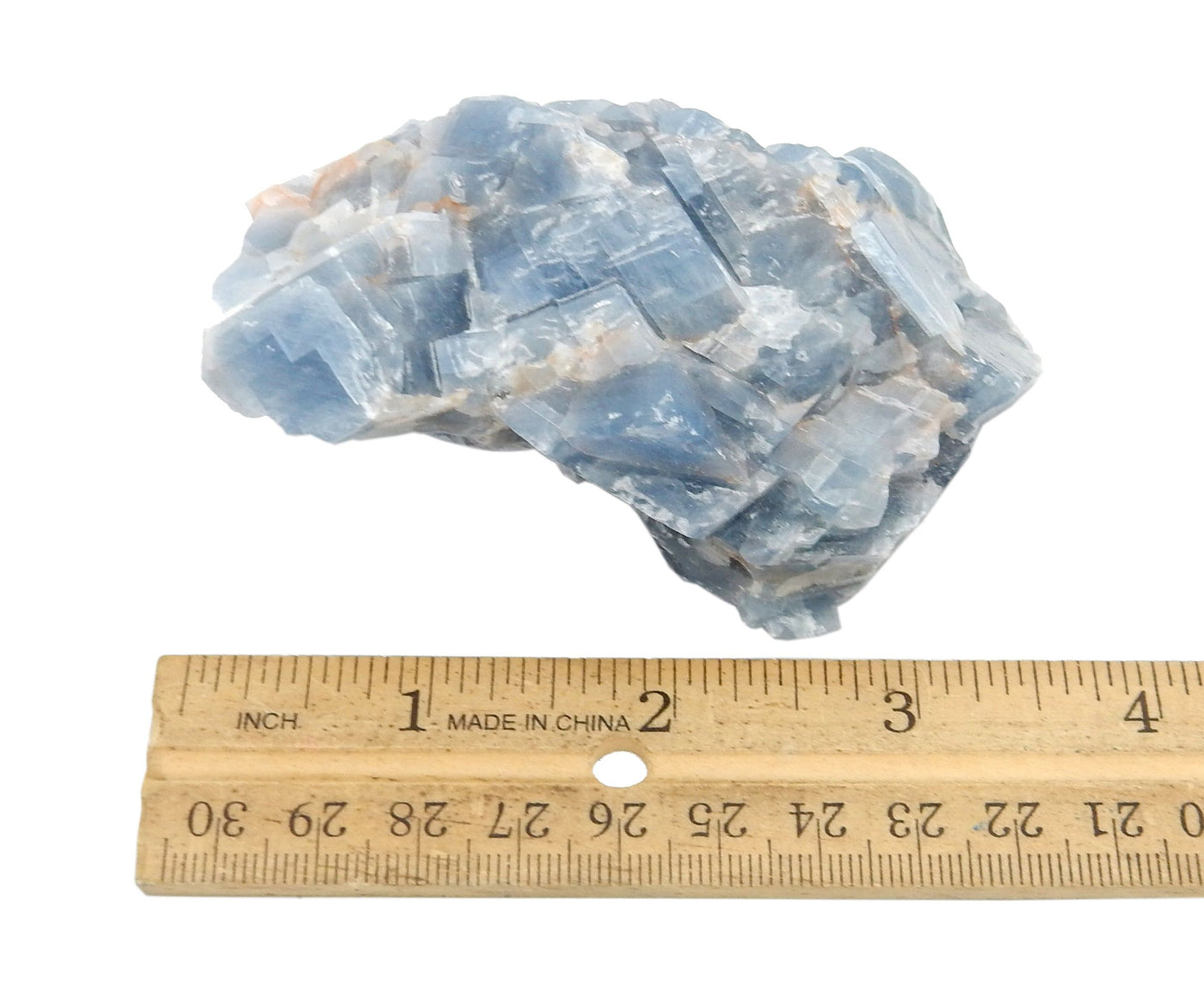 blue calcite stone next to ruler for size comparison