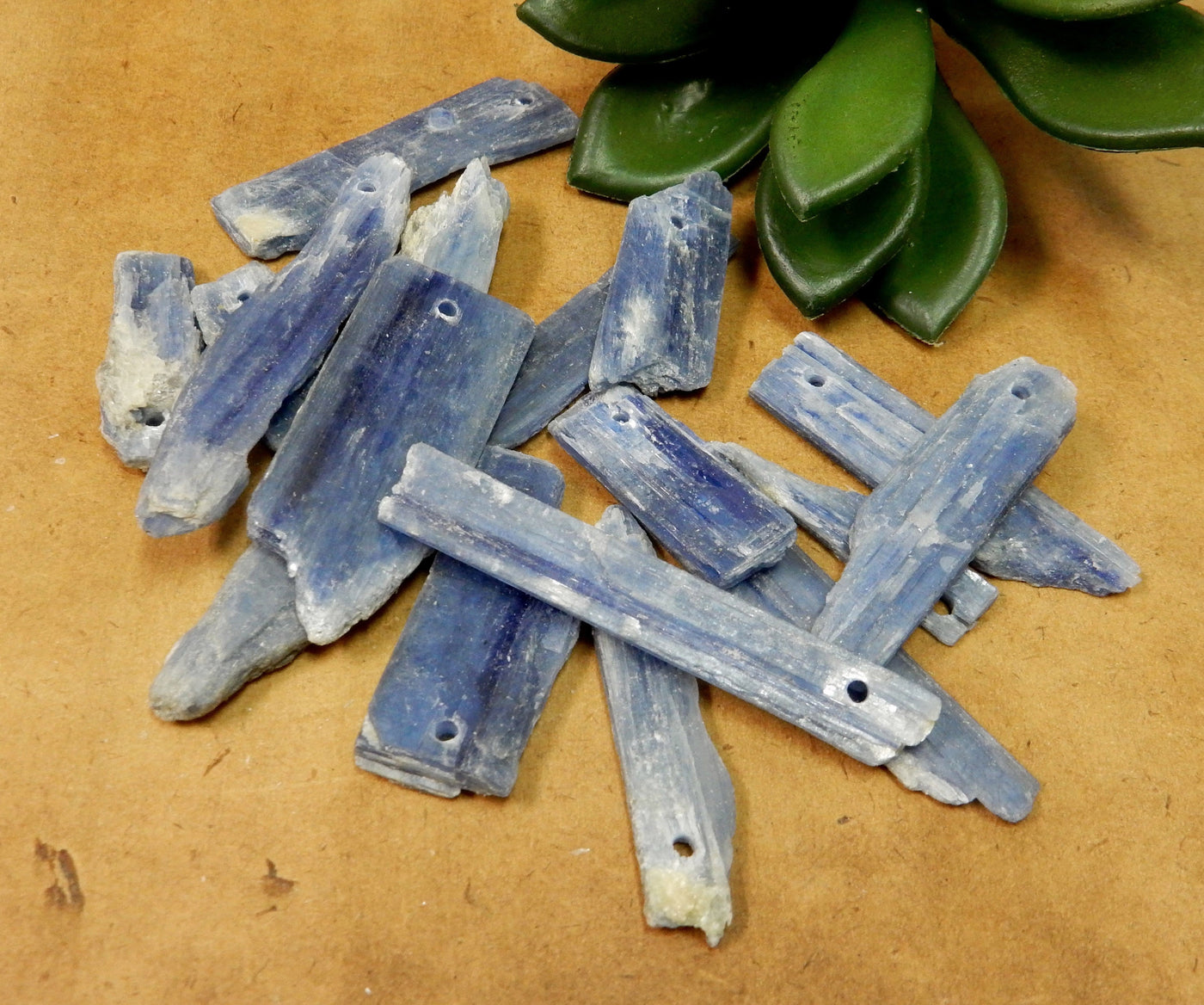 Blue Kyanite Blades Top Drilled Beads on a table showing a variety of sizes and shapes