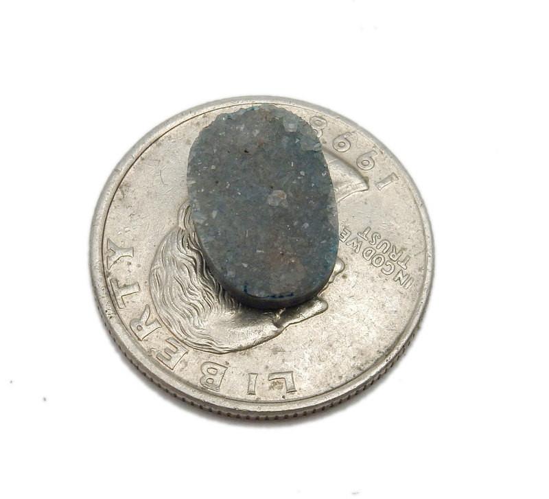 blue druzy oval next to a quarter for size reference 